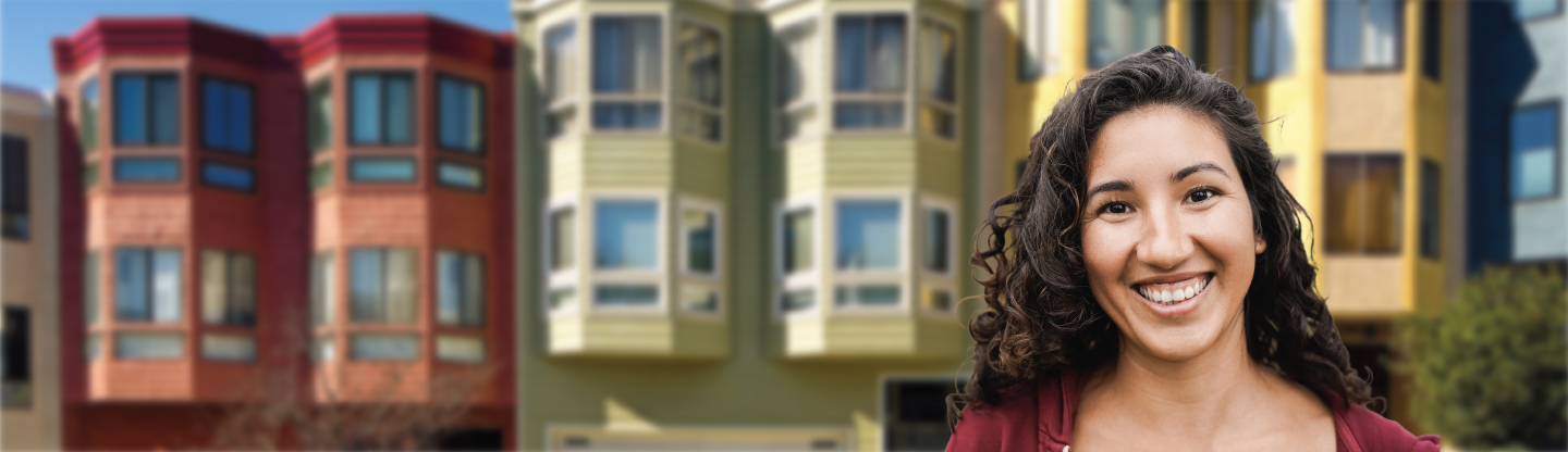 A women standing in front of a row of San Francisco houses.